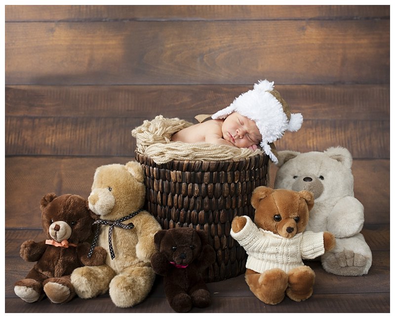 baby sleeping surrounded by stuffed animals.jpg