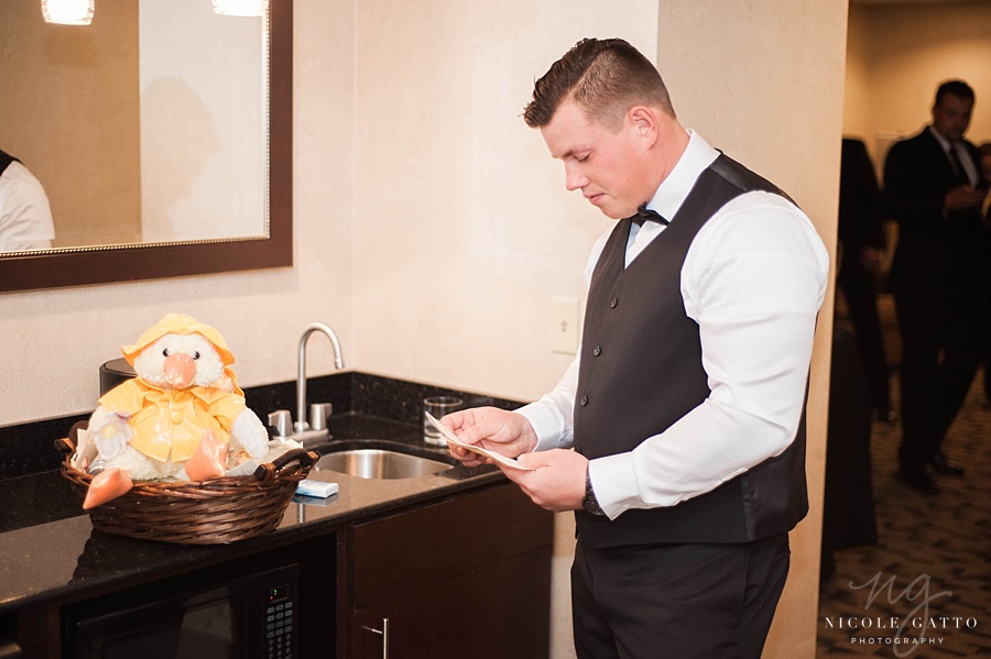 Groom reading note at embassy suites