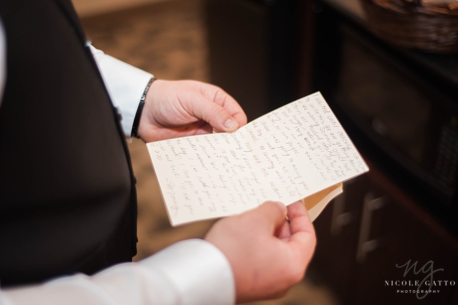 Wedding Photographers Buffalo groom reading note from bride