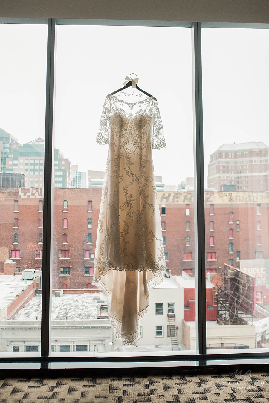 photograph of brides dress in window at embassy suites