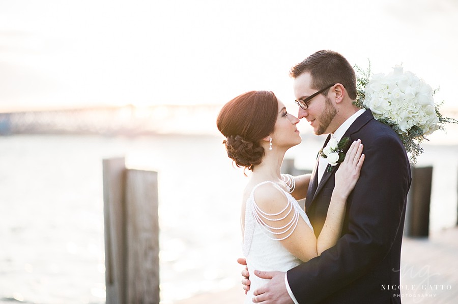 Bride and groom standing in front of bridge