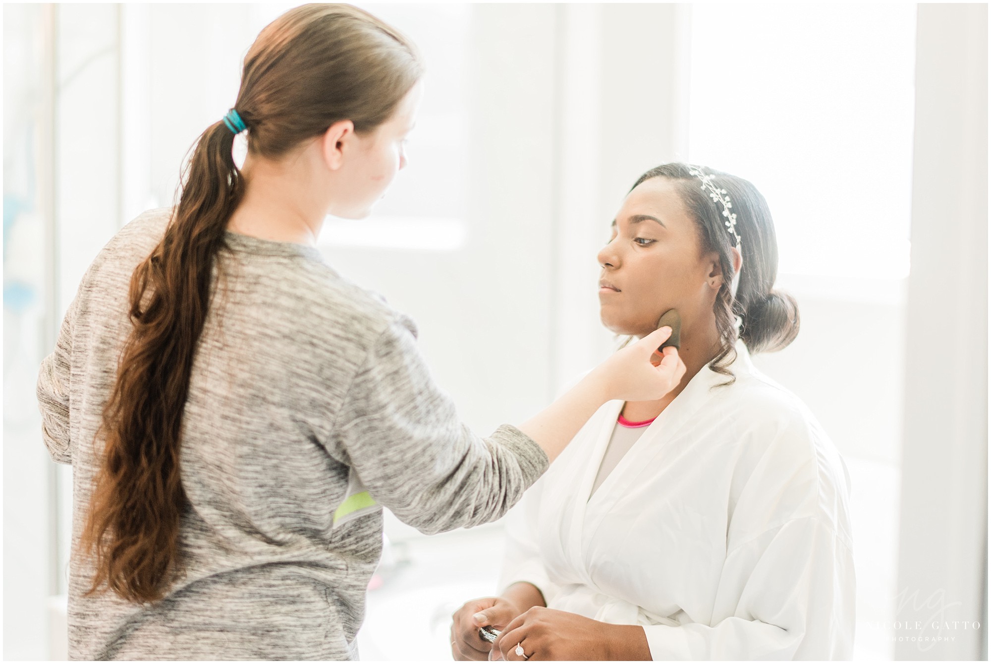 bride getting makeup put on