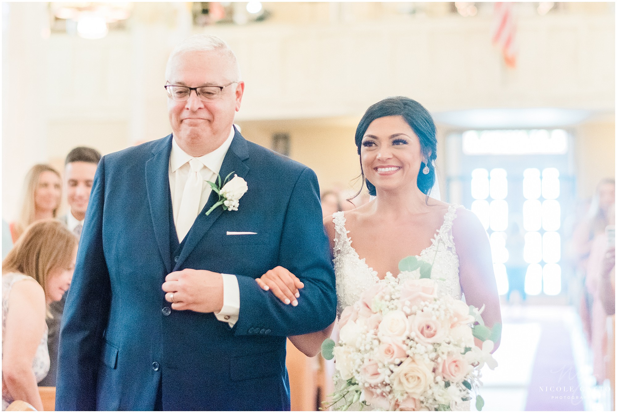 bride and father walking down the aisle for wedding at holy family of jesus mary and joseph in NIagara Falls