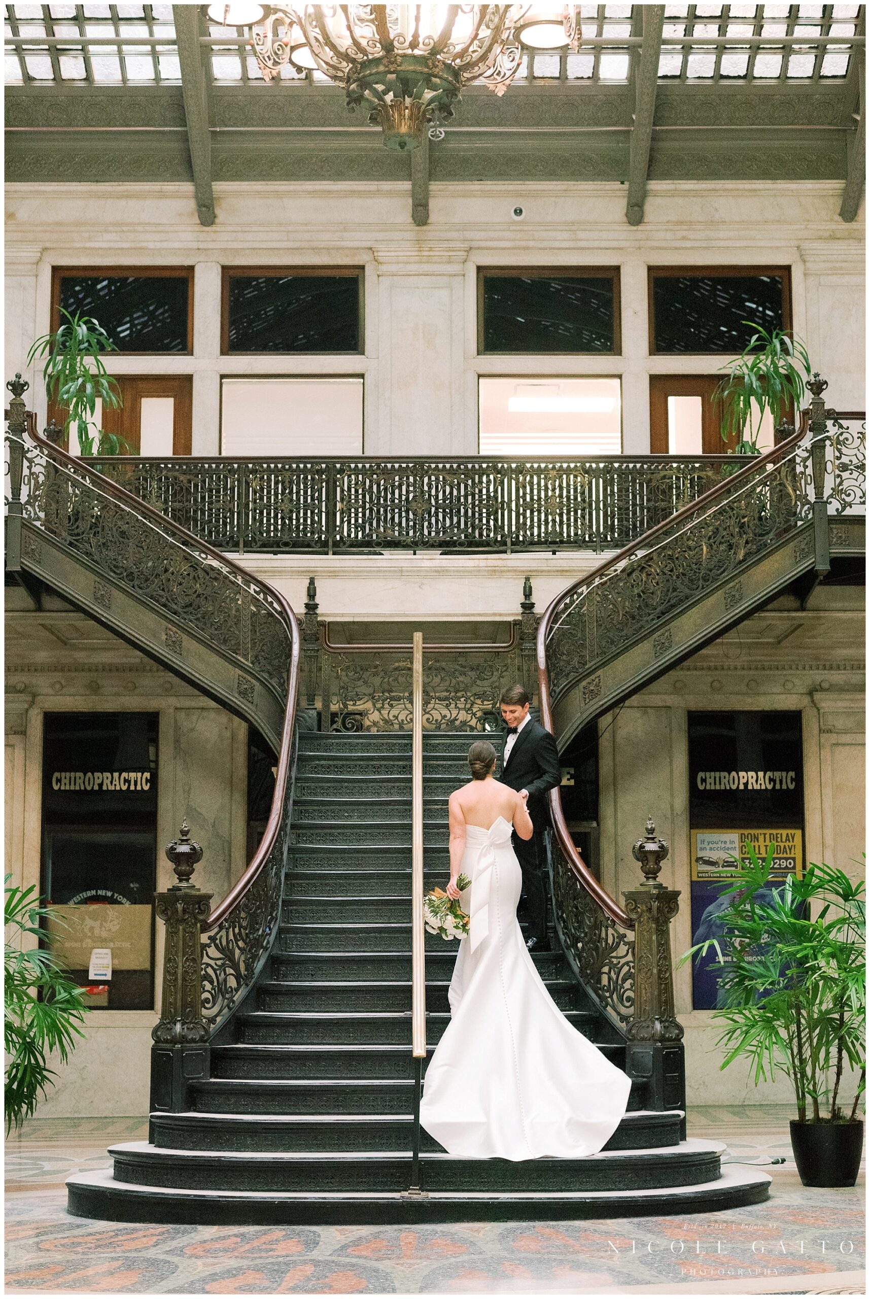 bride and groom walking up stairs at ellicott squre building 