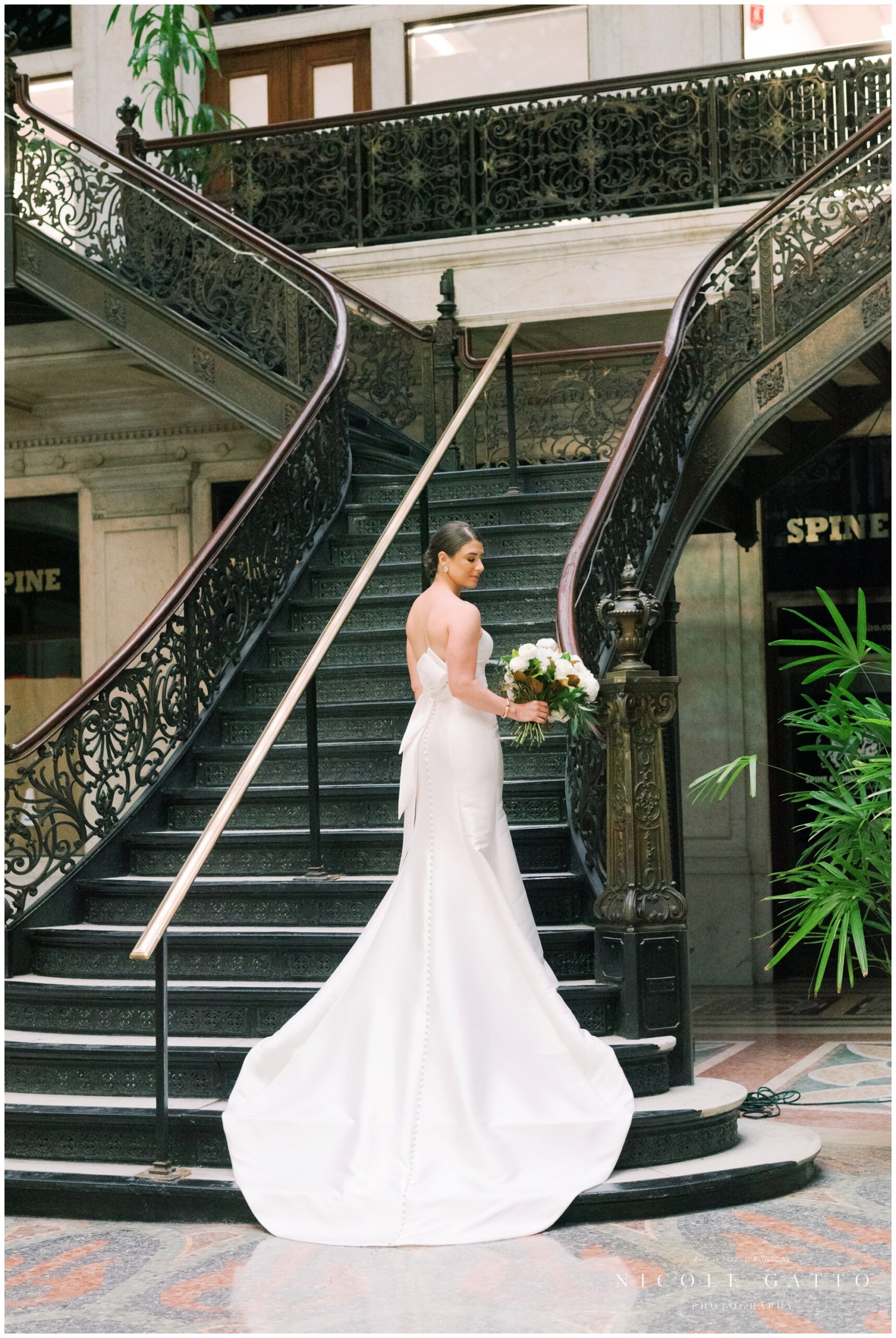 bride standing alone on stairs at ellicot square building