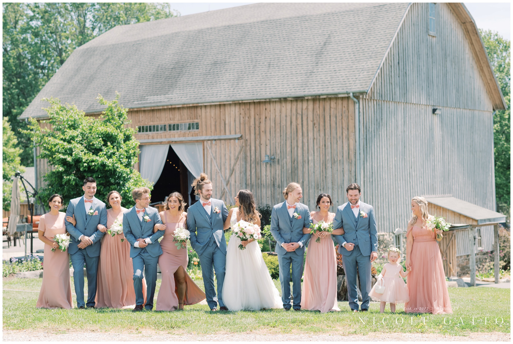 bridal party portrait in front of barn at hayloft in the grove