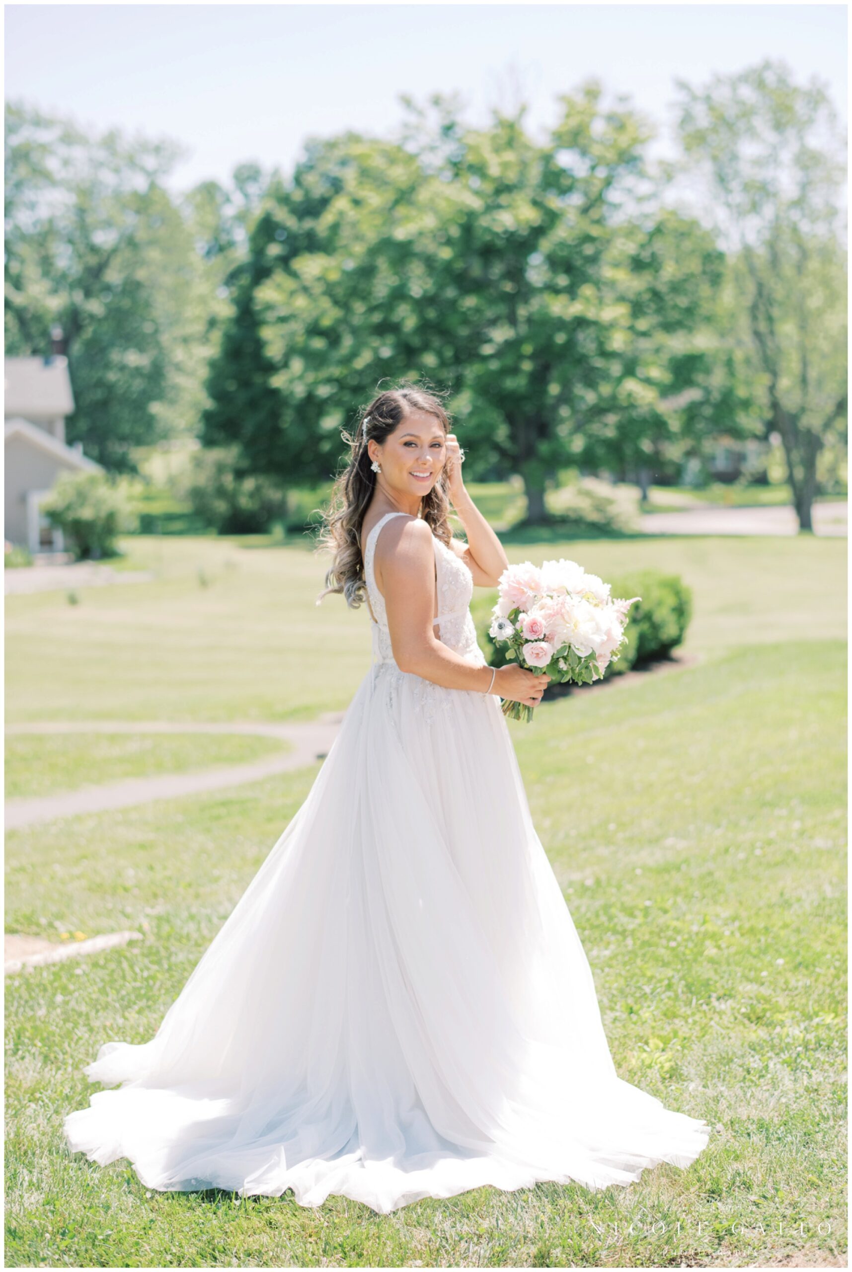 bride by herself looking over shoulder for wedding at Hayloft in the grove 