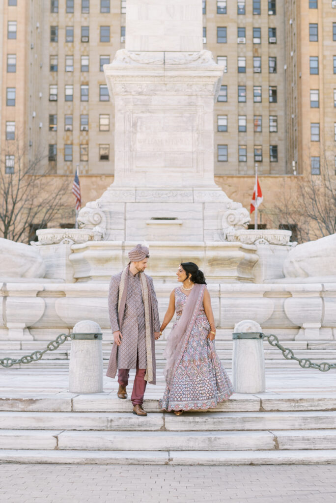 Indian bride and groom walking down steps in buffalo ny in traditional Indian wedding dress for Sangeet